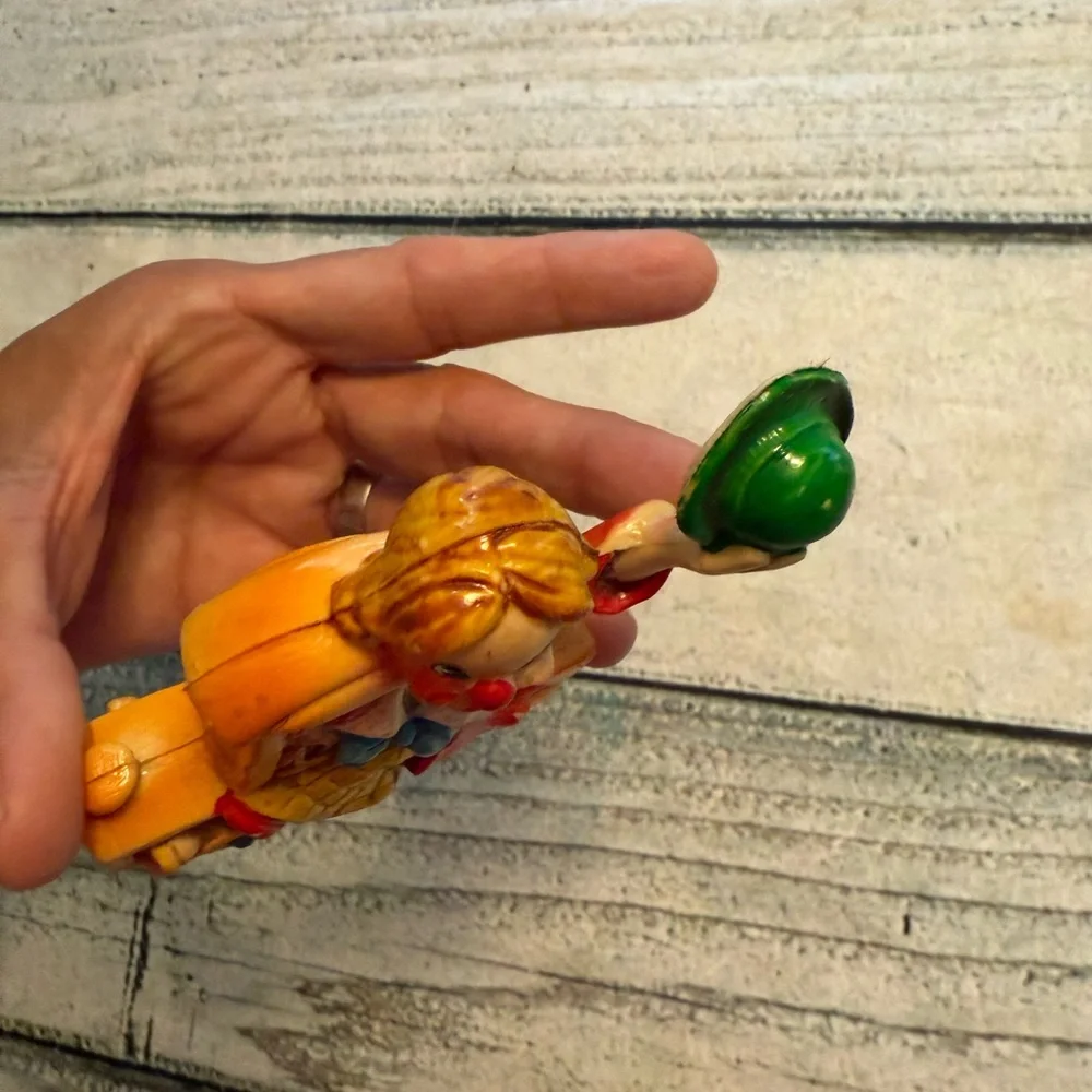 Vintage clown figurine riding in a car. Made in Japan.